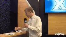 Man holding microphone says absolutely exquisite and delightful