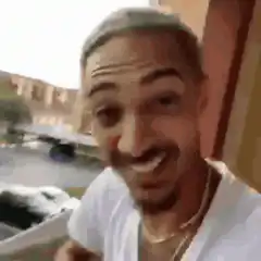 Man laughing and looking around excitedly