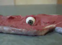 Raw meat with a moving eyeball