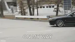 black car drifting on road