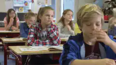 Girl looks bored in class while boy facepalms