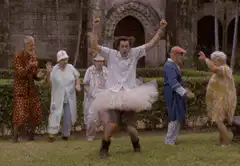 man in tutu dancing with elderly people