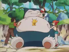 Ash, Brock, and Misty pushing Snorlax