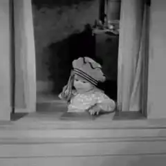 Baby in hat throws something out window
