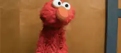 Elmo looking around confused
