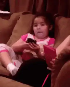 Girl eating chocolate and looking at phone