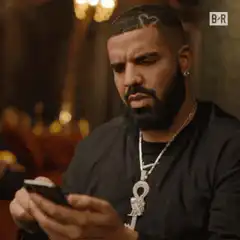 Drake looking at phone
