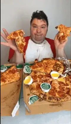 Man eats pizza with hands