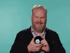 Jim Gaffigan laughs holding an 8 ball