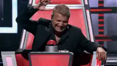 Alec Baldwin presses the red buzzer