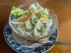Cucumber and cabbage salad in glass bowl