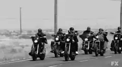 Sons of Anarchy bikers riding and waving