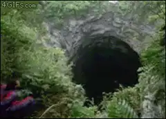 Man jumps into a deep cave