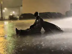 Batman sitting in the rain