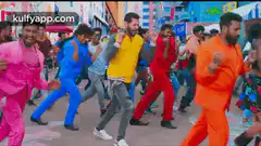 Men in colorful suits dancing in street