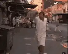 Man in bathrobe dancing on street