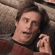 Jim Carrey lying on couch with a fly