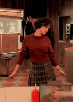 Woman in red sweater tilting head