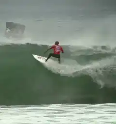 Surfer aerial maneuver on big wave