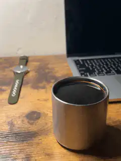 watch and coffee cup on desk