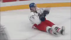 Hockey player falls and slides on ice