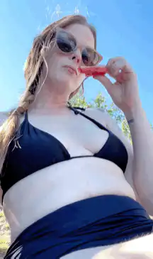 Woman in bikini eating a popsicle