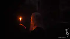 Woman holding a torch in the dark