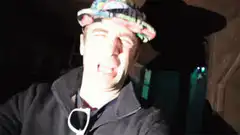 Man singing passionately in a hat