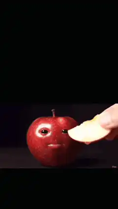 Apple with face eating apple slice