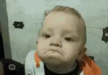 Baby looks down and pouts