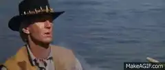 Man eats corn on the cob in a boat