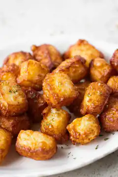 golden crispy tater tots on white plate