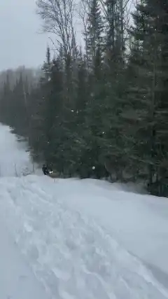 Snowmobile jumps and drifts in snow