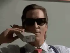 Agent Smith holding a brick phone