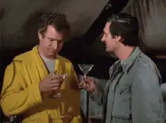 Two men toast and drink martinis