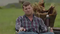 Man smoking in a field