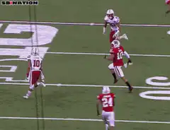 Football player tackled and flips over