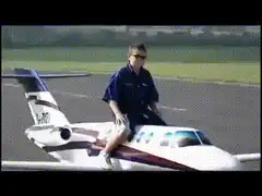 Man riding a small plane on a runway
