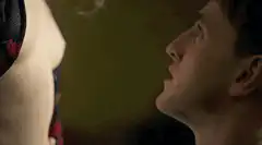 Man kissing woman's chest
