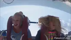 Two girls screaming on a roller coaster