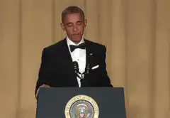 Obama coughs into hand at podium