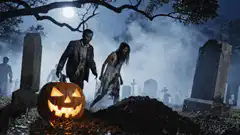 Zombies rising from grave with pumpkin
