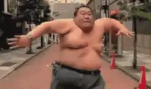 Sumo wrestler dancing on street