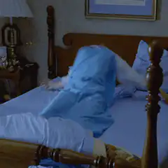 Woman thrashing in bed with messy hair