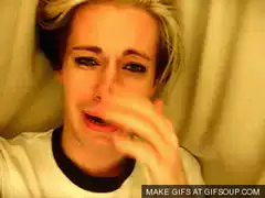 Sad blonde person crying and wiping tears