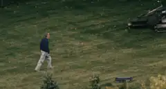 Man slips and falls on grassy hill