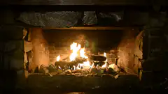 Fire burning in a stone fireplace