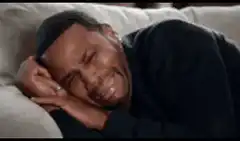 Man crying in bed