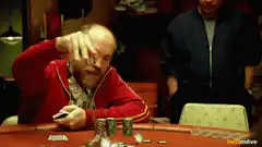 Man in red jacket playing poker