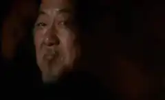 Old man smiling in dark